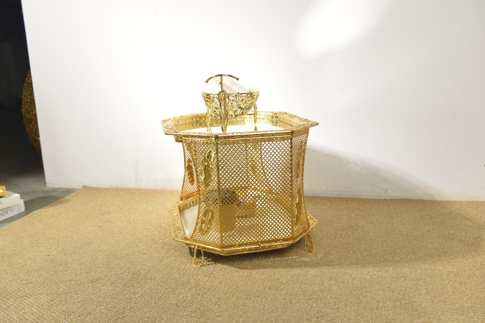 Gold filigree coffee table styled with decor in factory showroom