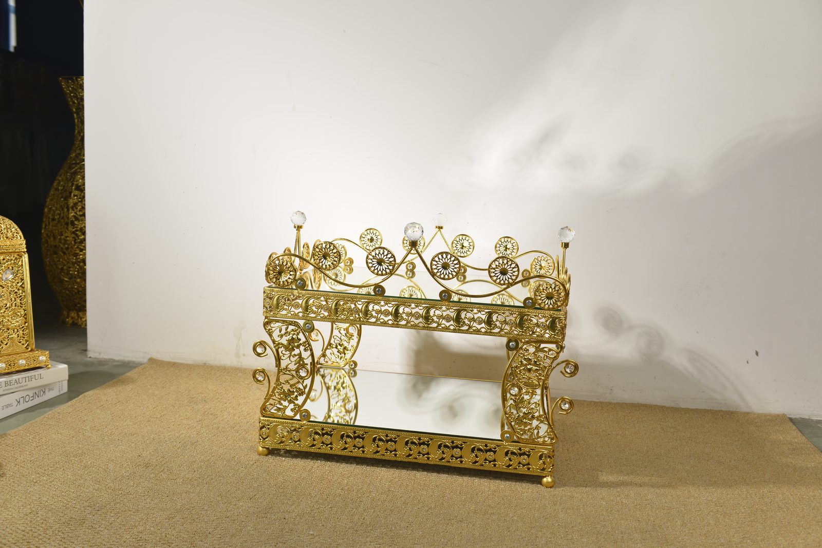 Gold filigree console table with crystal finials and mirrored base